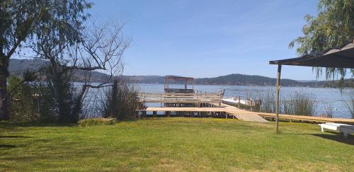 a dock on a body of water with a view at Maravillosa cabaña en orilla de Lago Vichuquén in El Rodeo