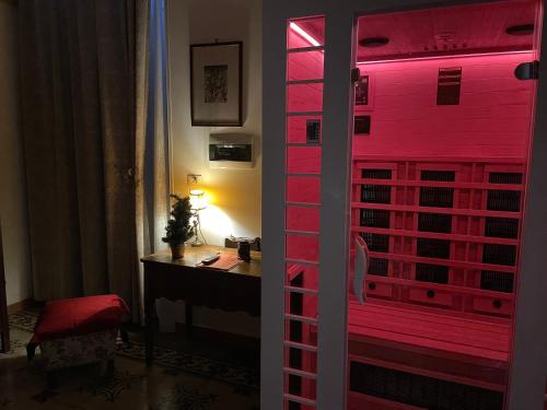 a door to a room with pink lights on it at B&B ME Palace in Nardò
