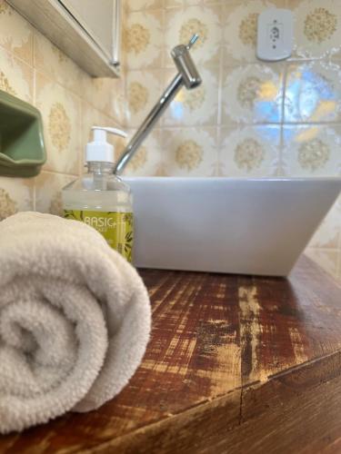 a bathroom counter with a towel and a sink at Deck Hospedaria in Cunha