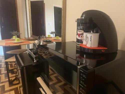a coffee machine sitting on a counter in a room at Deck Hospedaria in Cunha