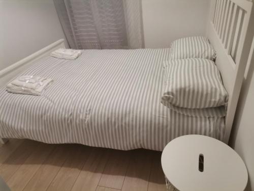 a small bed and a chair in a room at S & K Apartment free indoor parking in Athens