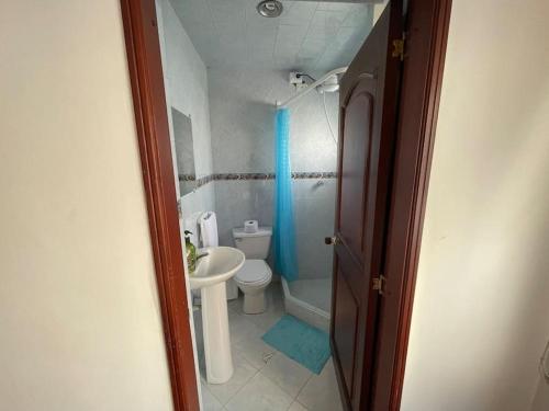 a small bathroom with a toilet and a sink at Casa Linda in Bogotá