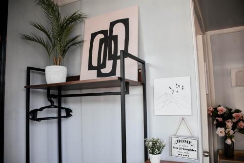 a black shelf with a picture on it in a room at Olive Hostel Roxas City in Roxas City