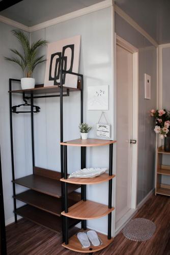a shelf in a room with wooden shelves at Olive Hostel Roxas City in Roxas City