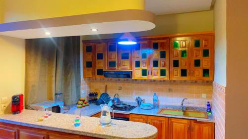 a kitchen with wooden cabinets and a counter top at Villa Marrakech in Marrakesh