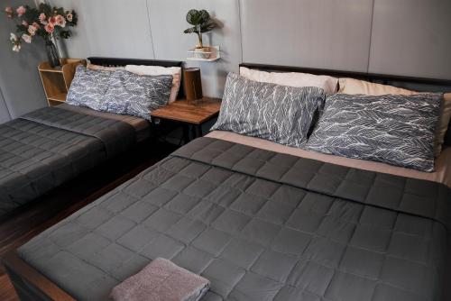 a living room with a bed and a couch at Olive Hostel Roxas City in Roxas City