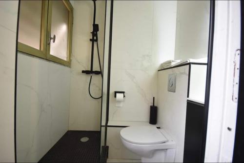 a bathroom with a toilet and a glass door at Prado Marseille 8eme studio in Marseille