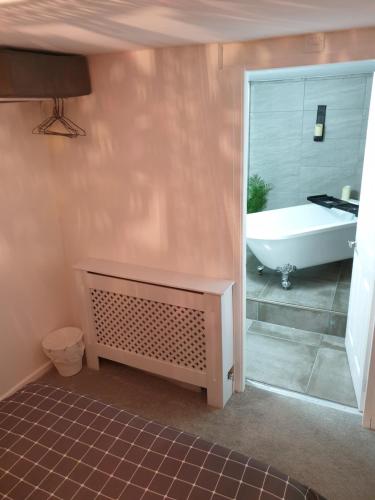 a bathroom with a tub and a sink and a bath tub at Penbryn Holidays No 2 in Barmouth