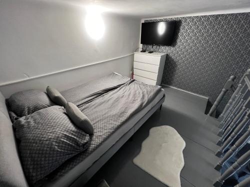 a small bedroom with a bed and a tv at Dave Apartman 2 in Szeged