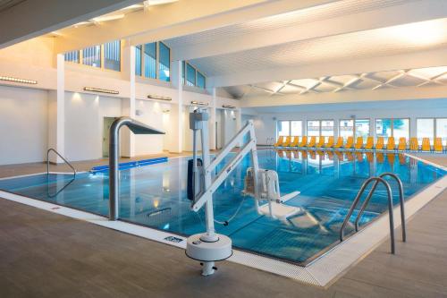 a large indoor swimming pool with blue water at Haus Martha in Kaunertal