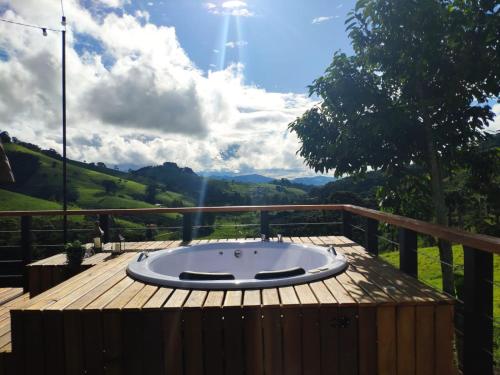 a hot tub sitting on top of a wooden deck at Cabana Mundo Novo in Gonçalves
