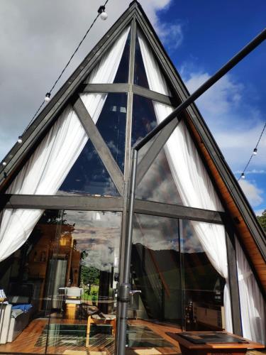 a triangular building with large glass windows at Cabana Mundo Novo in Gonçalves