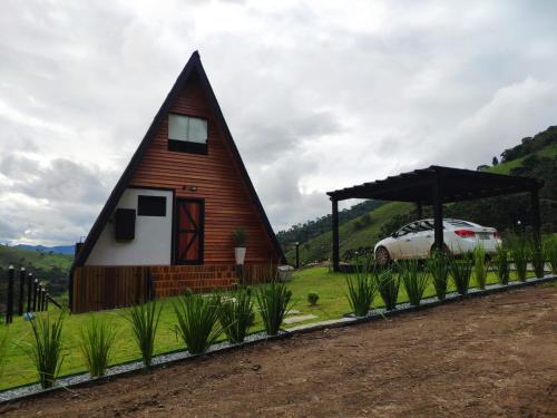 a small house with a car parked next to it at Cabana Mundo Novo in Gonçalves