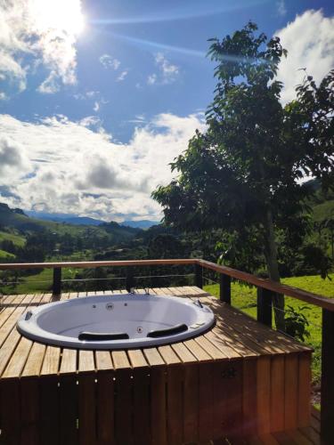 a hot tub on a wooden deck with a view at Cabana Mundo Novo in Gonçalves