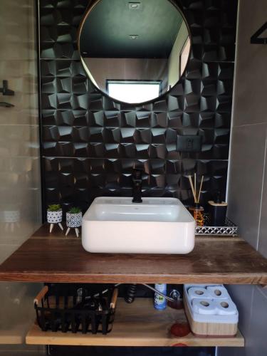 a bathroom with a white sink and a mirror at Cabana Mundo Novo in Gonçalves