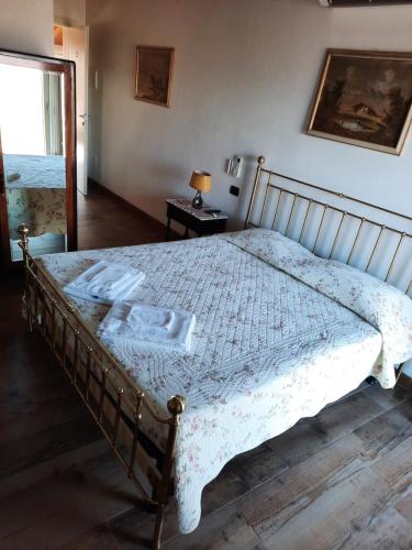 a bedroom with a bed with a white comforter at B&B Casa Santa Lucia in Manerba del Garda