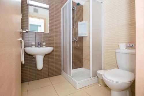 een badkamer met een toilet, een wastafel en een douche bij GABRIELA - Beachfront Apartment in Protaras