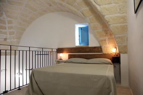um quarto com uma cama e uma janela azul em La Corte dei Colori em Spongano