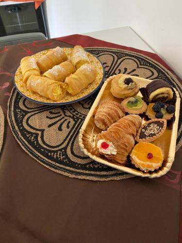 two plates of pastries and cookies on a table at La Fortezza dei Sanniti 