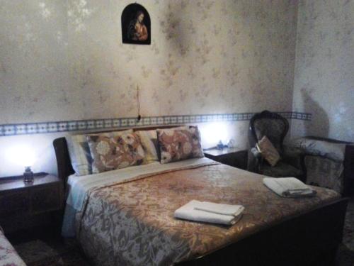 a bedroom with a bed with two towels on it at La Dimora di Anna in Naples