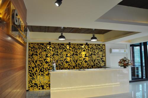 a kitchen with a yellow and black patterned wall at The Gallery At Koh Chang in Ko Chang