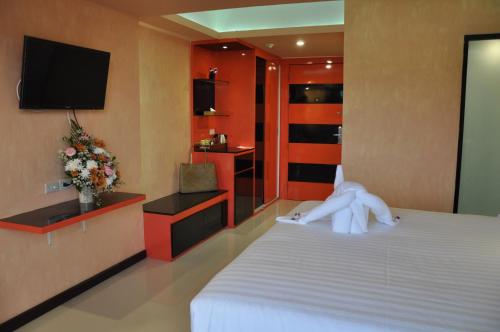 a hotel room with a bed with a towel on it at The Gallery At Koh Chang in Ko Chang
