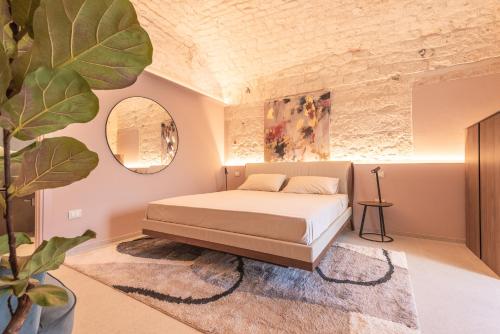 a bedroom with a bed and a potted plant at Villa Ada-Trulli Puglia in Martina Franca