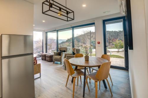 a kitchen and dining room with a table and chairs at Casas de Tourim in Arcos de Valdevez