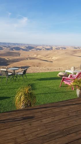 a group of tables and chairs on top of a field at Sun, Mountain & Adventure in Arad