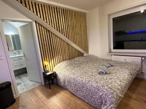 a bedroom with a bed and a large window at Amazing Hyper Central Flat- Esch in Esch-sur-Alzette