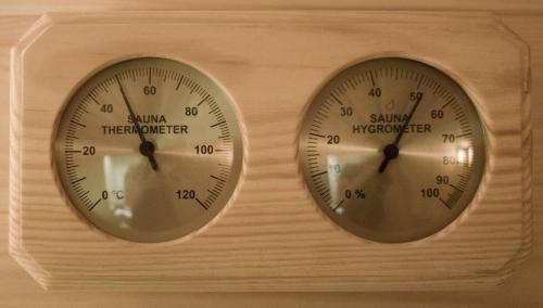 two thermometers sitting next to each other at Pension Panorama in Odorheiu Secuiesc