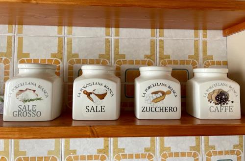 a shelf with four jars of food on it at Chalet dell'Orso in Pescasseroli