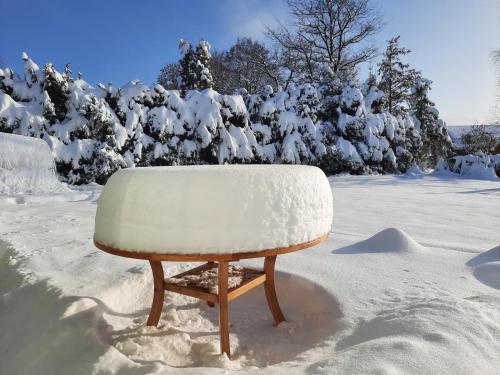 a snow covered chair sitting in the snow at V přírodě na okraji Frenštátu pod Radhoštěm in Frenštát pod Radhoštěm