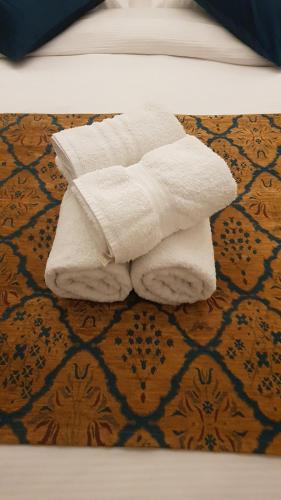a pile of white towels sitting on the floor at Sun, Mountain & Adventure in Arad
