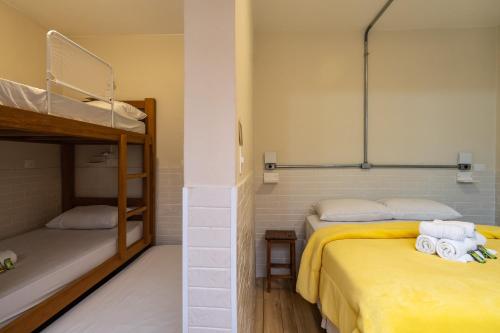 a bedroom with two bunk beds with towels at Hostel B2B SP in Sao Paulo