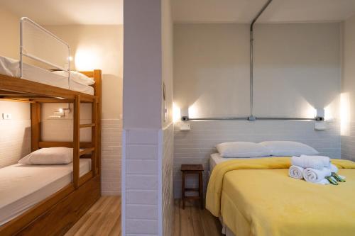 a bedroom with two beds and a bunk bed at Hostel B2B SP in Sao Paulo