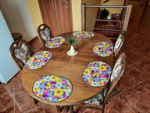 a wooden table with colorful plates on it at V přírodě na okraji Frenštátu pod Radhoštěm in Frenštát pod Radhoštěm