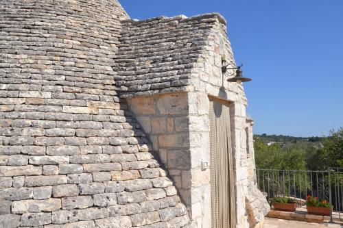 a stone wall with a door on a building at Masseria Montanaro in Cisternino