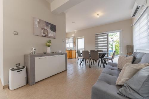 a living room with a couch and a table at Villa Mespila_ Ayia Napa in Ayia Napa