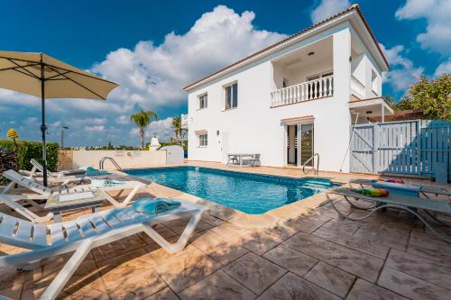 a villa with a swimming pool and a house at Villa Mespila_ Ayia Napa in Ayia Napa