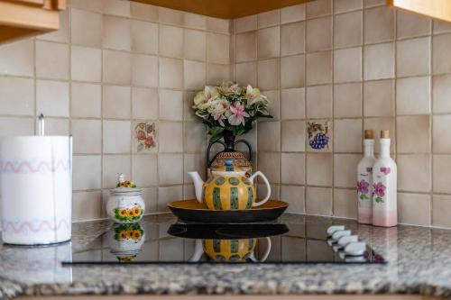a counter top with a vase and a bowl with flowers at Villa Mespila_ Ayia Napa in Ayia Napa