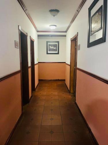 an empty hallway with doors and a tile floor at Boutique Hotel Calle 20 in San José