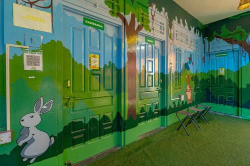 a room with a mural of a rabbit on the wall at Jungle Hostel by Whoopers in Kasol