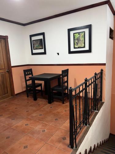 a dining room with a black table and chairs at Boutique Hotel Calle 20 in San José