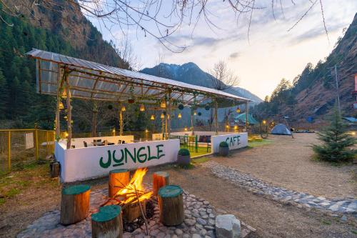 a pavilion with a tent in the mountains at Jungle Hostel by Whoopers in Kasol