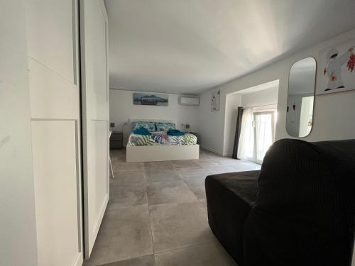 a living room with a bed and a mirror at Lucullo's Rooftop in Naples