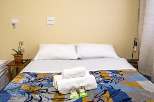 a bedroom with a bed with towels on it at Hostel B2B SP in Sao Paulo