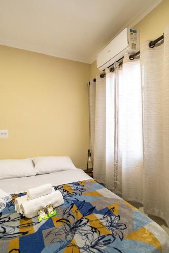 a bedroom with a bed with towels on it at Hostel B2B SP in Sao Paulo