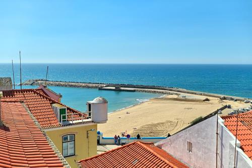 a view of a beach from the roofs of buildings at Village Center - Ocean View in Ericeira