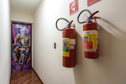 two fire hydrants are hanging on a wall at Hostel B2B SP in Sao Paulo